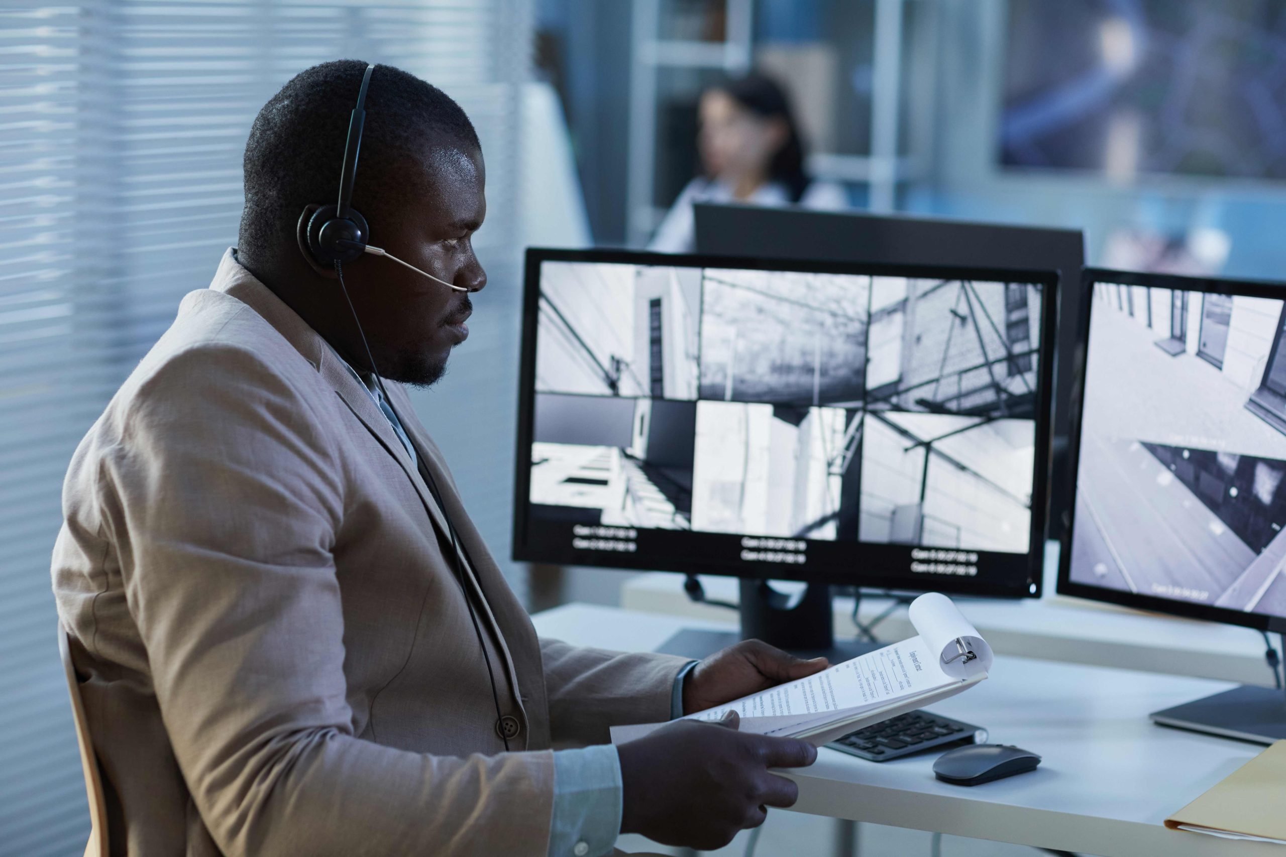 black-man-wearing-headset-while-watching-surveilla-2023-11-27-05-19-05-utc