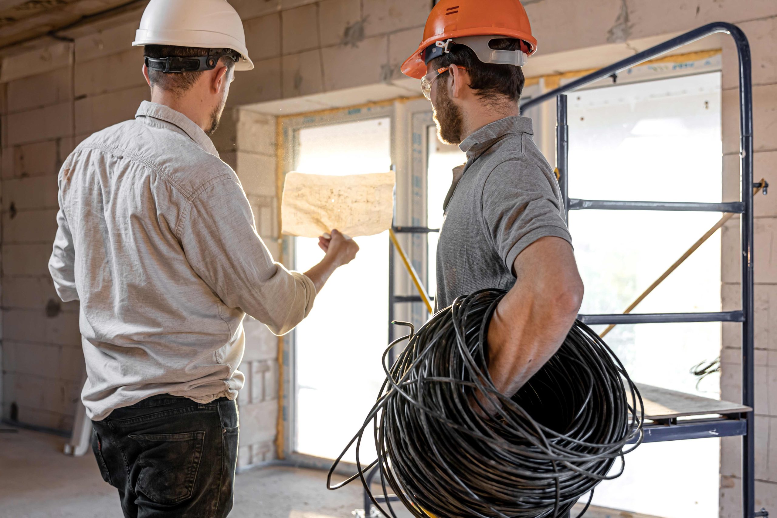 two-builders-look-at-the-drawing-of-the-object-2023-11-27-04-50-30-utc